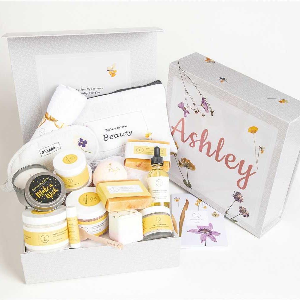 Get-well gift basket designed to brighten someone's day, featuring a Citrus Bath set filled with pampering items. The set includes a 4oz natural citrus soap bar, a 4oz ylang ylang orange soap bar, a 9oz grapefruit body scrub, a 9oz citrus bath salt jar, a large bath bomb, an eye mask, a cosmetic bag, a large shower steamer (2" diameter), a 1oz clay facial mask for multiple uses, a 2oz grapefruit shea butter, a 2oz grapefruit body oil, lip balm, a 4oz scented candle, a sponge/soap saver, and a face towel.